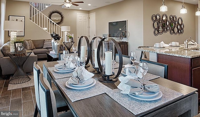dining room featuring a ceiling fan, recessed lighting, stairs, and baseboards
