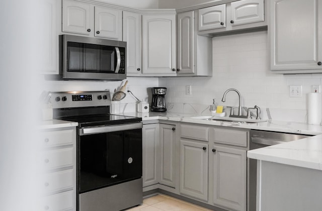 200 Kingsport Rd, Waynesboro, VA 22980 - kitchen featuring appliances with stainless steel finishes, light stone counters, light tile patterned floors, and tasteful backsplash