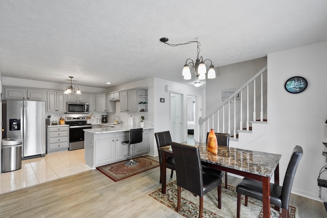 200 Kingsport Rd, Waynesboro, VA 22980 - dining room featuring a chandelier, light wood-style floors, stairway, and a textured ceiling