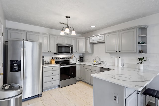 200 Kingsport Rd, Waynesboro, VA 22980 - kitchen with a peninsula, gray cabinetry, stainless steel appliances, light stone counters, and tasteful backsplash