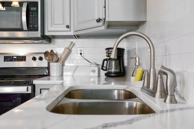 200 Kingsport Rd, Waynesboro, VA 22980 - kitchen view of appliances with stainless steel finishes, light stone countertops, and tasteful backsplash
