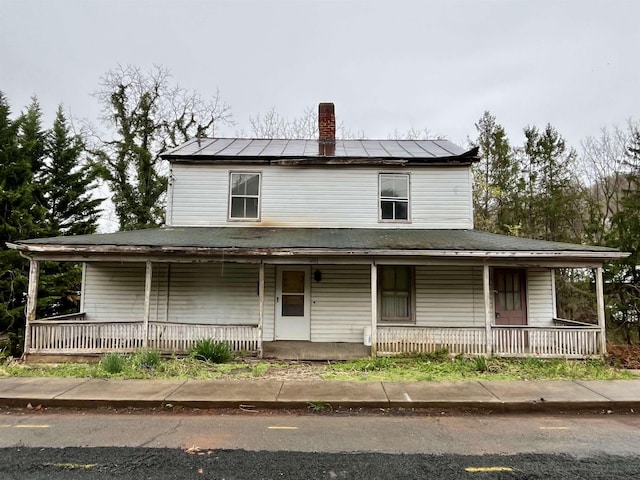 1201 Burnett St, Staunton, VA 24401 - country-style home with covered porch, roof mounted solar panels, and a chimney