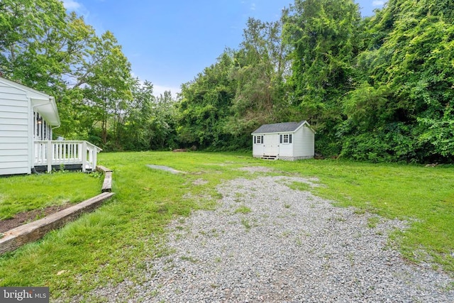 19012 Lahore Rd, Orange, VA 22960 - view of grassy yard with a shed, gravel driveway, a wooden deck, and a wooded view