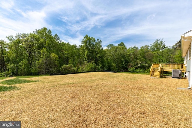 2434 Repton Mill Rd, Aroda, VA 22709 - view of green lawn featuring a wooden deck, central AC, and stairway