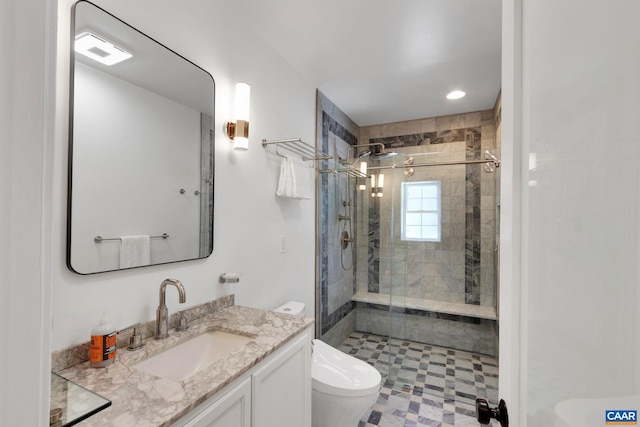 bathroom featuring tile patterned floors, vanity, toilet, and a stall shower