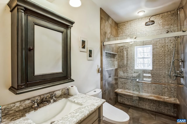 full bathroom with vanity, toilet, and a shower stall