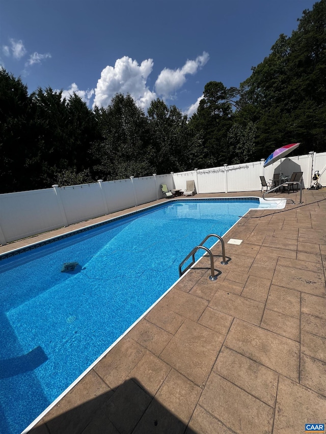 view of swimming pool with a patio area, a fenced in pool, and a fenced backyard