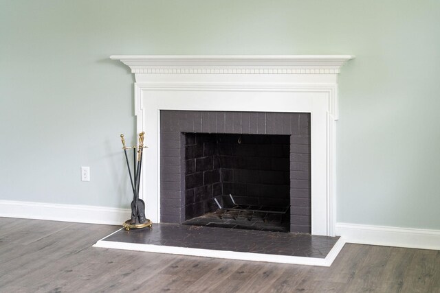 402 Marshall St, Staunton, VA 24401 - detailed view of baseboards, a fireplace with raised hearth, and wood finished floors