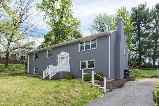 402 Marshall St, Staunton, VA 24401 - bi-level home featuring a chimney, a front yard, and brick siding