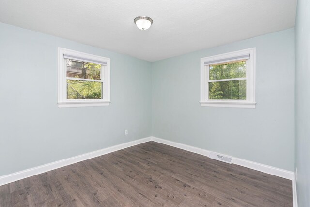 402 Marshall St, Staunton, VA 24401 - empty room featuring healthy amount of natural light, baseboards, and dark wood-style flooring