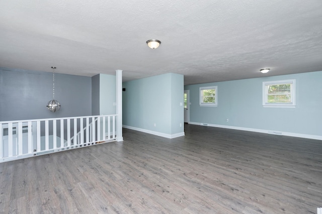 402 Marshall St, Staunton, VA 24401 - spare room with wood finished floors, a textured ceiling, and a chandelier