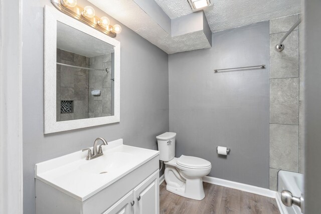 402 Marshall St, Staunton, VA 24401 - bathroom featuring a shower, wood finished floors, toilet, a textured ceiling, and vanity