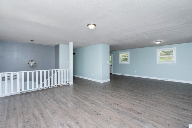 402 Marshall St, Staunton, VA 24401 - spare room with wood finished floors, baseboards, a textured ceiling, and a chandelier