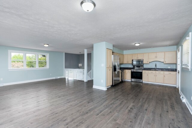 402 Marshall St, Staunton, VA 24401 - kitchen with appliances with stainless steel finishes, open floor plan, dark countertops, a textured ceiling, and baseboards