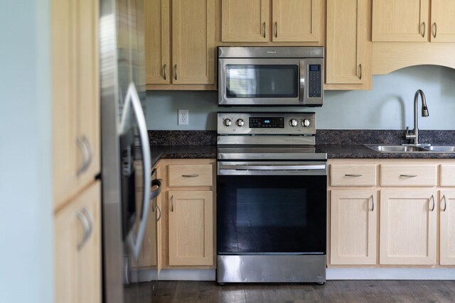 402 Marshall St, Staunton, VA 24401 - kitchen with appliances with stainless steel finishes, a sink, dark stone countertops, and light brown cabinetry