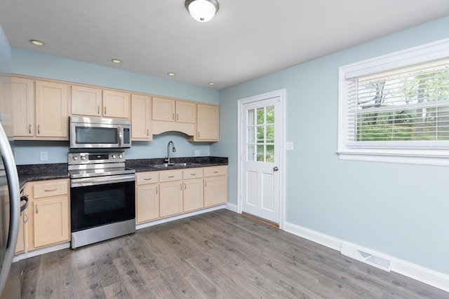 402 Marshall St, Staunton, VA 24401 - kitchen with stainless steel appliances, a sink, light brown cabinets, dark wood finished floors, and recessed lighting