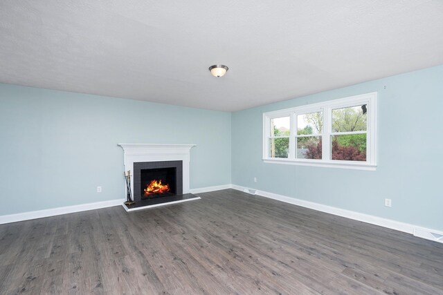 402 Marshall St, Staunton, VA 24401 - unfurnished living room featuring a lit fireplace, dark wood-style floors, and baseboards