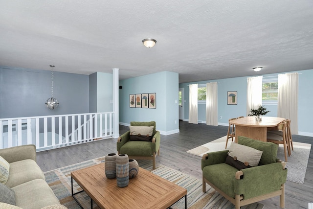 402 Marshall St, Staunton, VA 24401 - living area with wood finished floors, a chandelier, and a textured ceiling