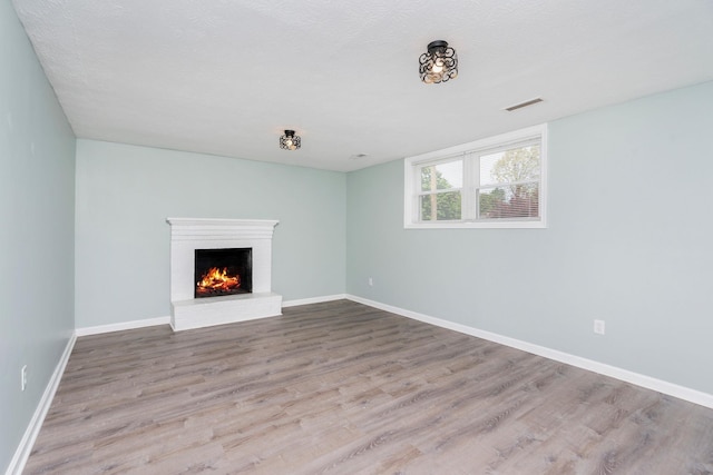 402 Marshall St, Staunton, VA 24401 - unfurnished living room featuring wood finished floors, a fireplace, and baseboards