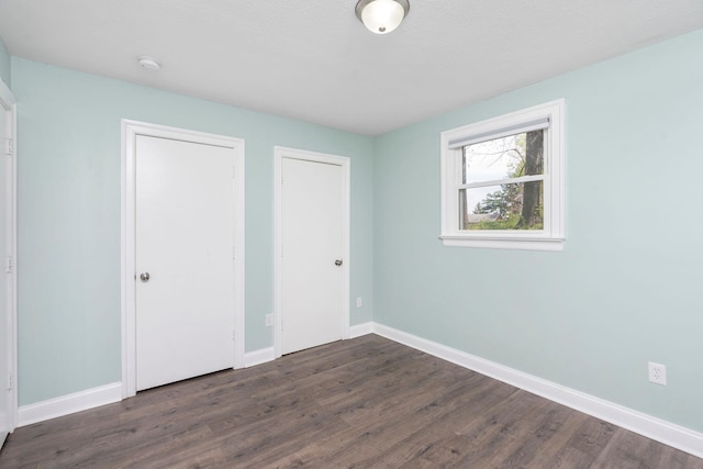 402 Marshall St, Staunton, VA 24401 - unfurnished bedroom with dark wood-style flooring and baseboards