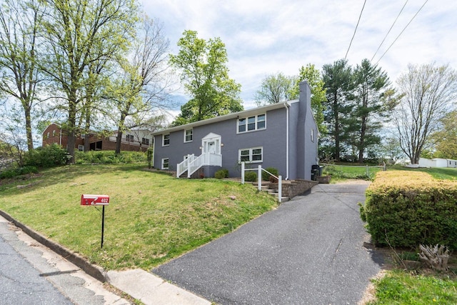 402 Marshall St, Staunton, VA 24401 - split foyer home featuring a chimney, a front yard, and asphalt driveway