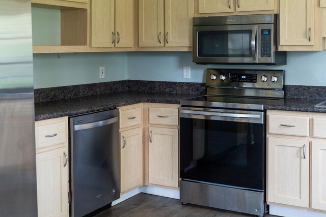 402 Marshall St, Staunton, VA 24401 - kitchen with appliances with stainless steel finishes, dark wood-style floors, and light brown cabinets