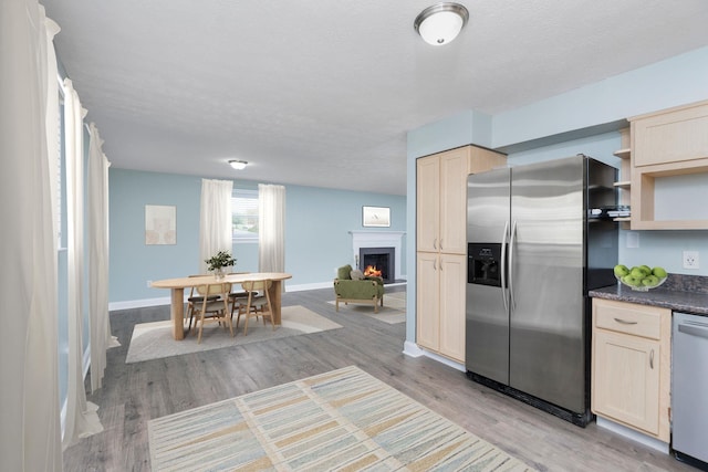 402 Marshall St, Staunton, VA 24401 - kitchen featuring appliances with stainless steel finishes, open shelves, dark countertops, light brown cabinets, and light wood-type flooring