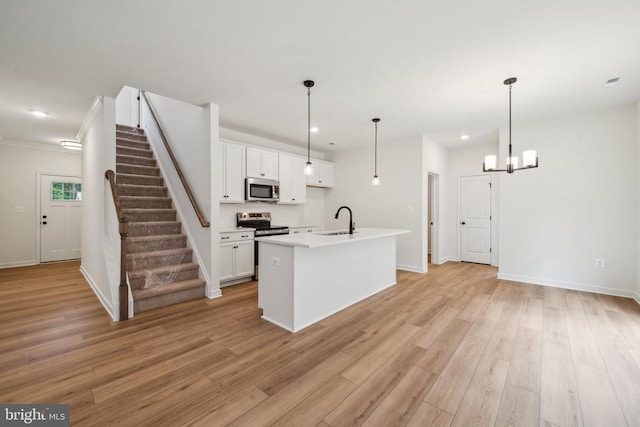 405 Richmond Ave, Mineral, VA 23117 - kitchen with stainless steel appliances, white cabinetry, recessed lighting, light wood-type flooring, and a center island with sink