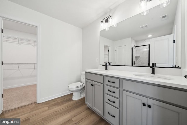405 Richmond Ave, Mineral, VA 23117 - bathroom with a shower stall, double vanity, wood finished floors, and a spacious closet