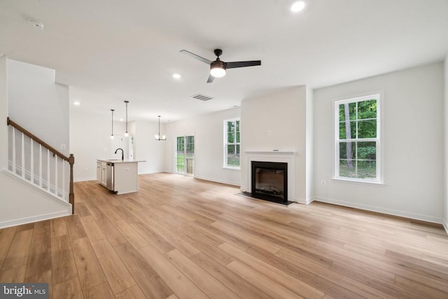 405 Richmond Ave, Mineral, VA 23117 - unfurnished living room with light wood finished floors, a fireplace with flush hearth, stairway, a ceiling fan, and recessed lighting