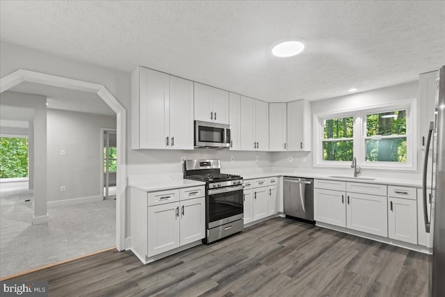 3050 Patriot Ln, Fredericksburg, VA 22408 - kitchen with appliances with stainless steel finishes, a textured ceiling, light countertops, white cabinets, and dark wood-style floors