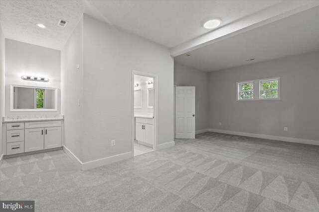 3050 Patriot Ln, Fredericksburg, VA 22408 - unfurnished bedroom featuring connected bathroom, light carpet, a textured ceiling, and recessed lighting