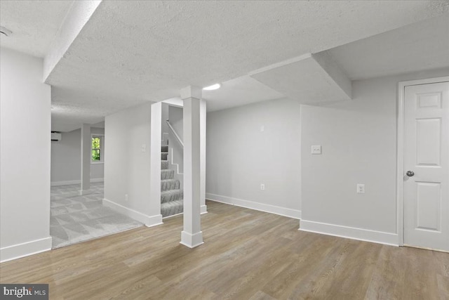 3050 Patriot Ln, Fredericksburg, VA 22408 - basement with a textured ceiling, light wood finished floors, and stairway