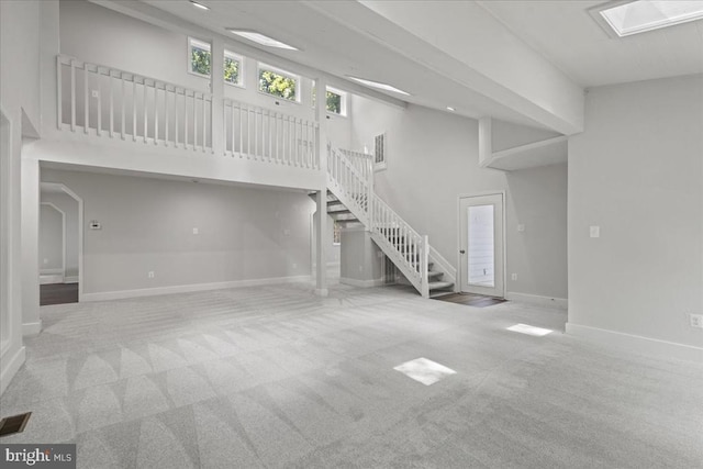 3050 Patriot Ln, Fredericksburg, VA 22408 - unfurnished living room with stairs, carpet floors, and a towering ceiling