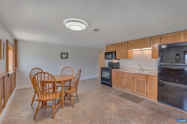 3340 James River Rd, Howardsville, VA 24562 - kitchen featuring baseboards, visible vents, a sink, black appliances, and light countertops