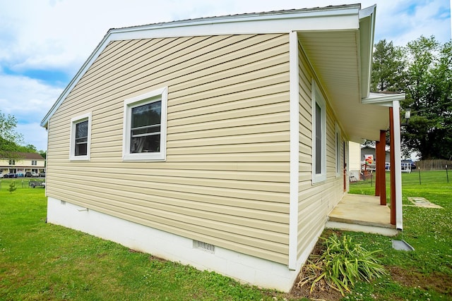 view of side of property featuring crawl space and a lawn