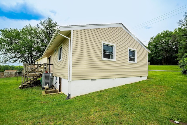 view of home's exterior featuring central AC, a yard, crawl space, and stairs
