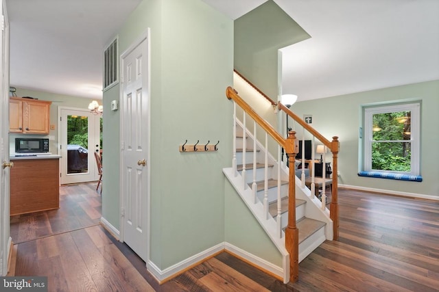 11332 Brinker Ct, Culpeper, VA 22701 - stairs with a chandelier, wood finished floors, and baseboards