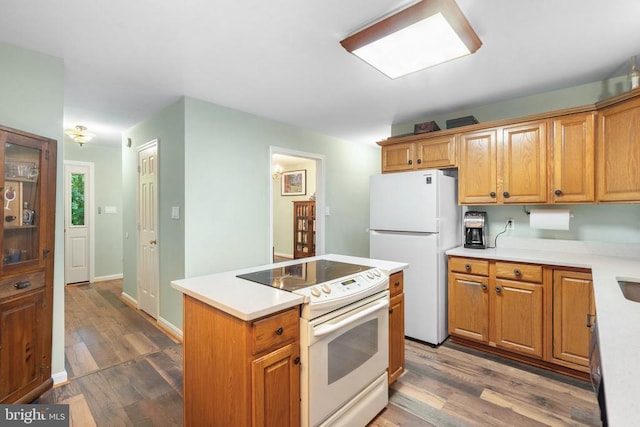 11332 Brinker Ct, Culpeper, VA 22701 - kitchen with white appliances, wood finished floors, light countertops, and a kitchen island