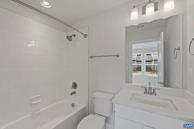 bathroom with vanity, toilet, bathing tub / shower combination, and visible vents