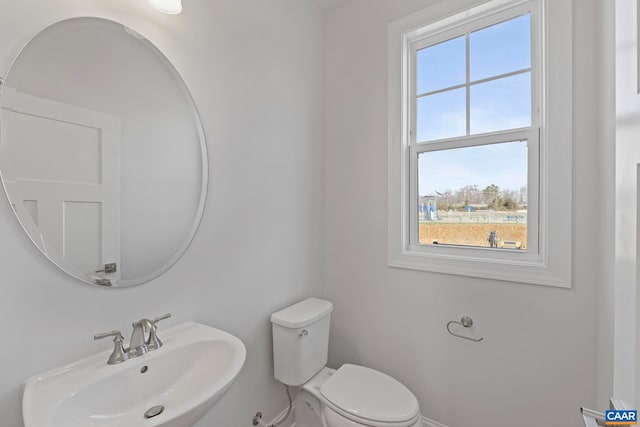 half bath with toilet and a sink