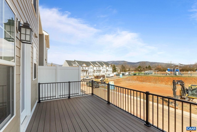 wooden deck with a residential view and a mountain view