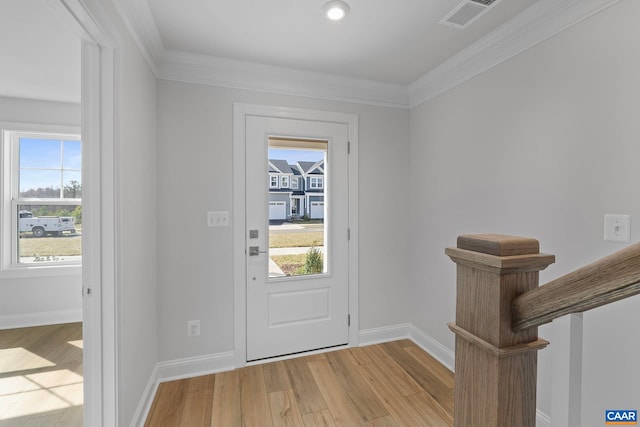 foyer entrance with baseboards, visible vents, light wood-type flooring, and plenty of natural light