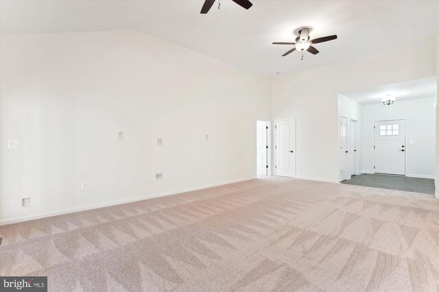  - unfurnished room featuring a ceiling fan, carpet, lofted ceiling, and baseboards