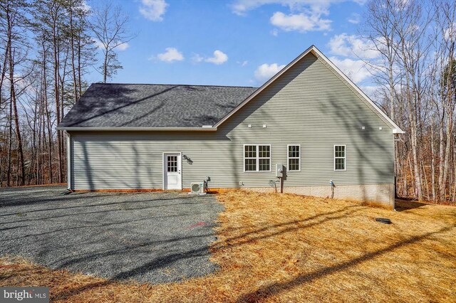  - rear view of house with a shingled roof
