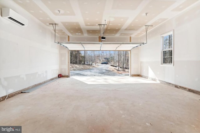  - garage featuring a wall unit AC and a garage door opener