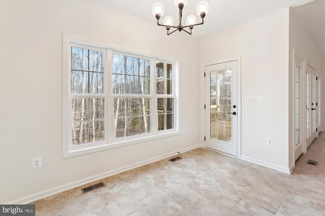  - unfurnished dining area with a chandelier, baseboards, and french doors