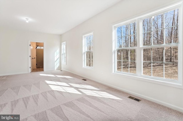 - spare room featuring carpet and baseboards