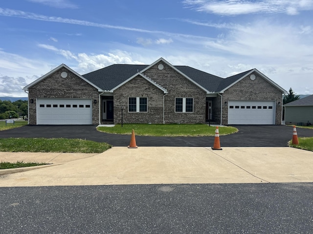 81 Meriwether Cir, Stuarts Draft, VA 24477 - view of front of home featuring asphalt driveway, brick siding, an attached garage, and a front lawn