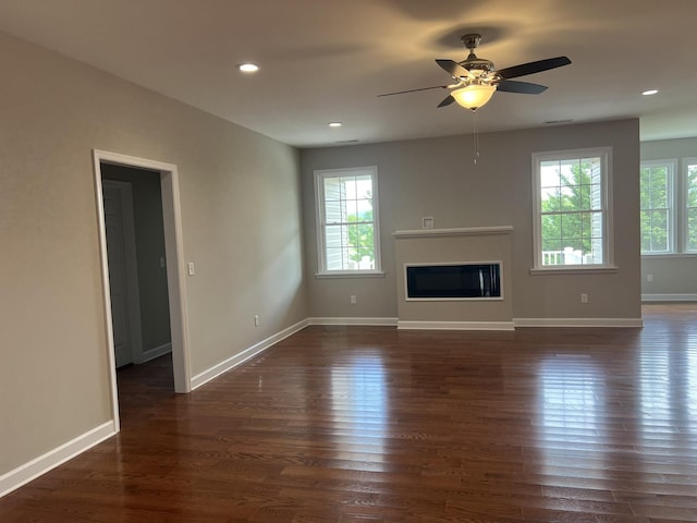 81 Meriwether Cir, Stuarts Draft, VA 24477 - unfurnished living room with dark wood-type flooring, a ceiling fan, baseboards, a glass covered fireplace, and recessed lighting